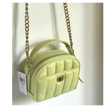 Load image into Gallery viewer, Light green handbag with gold chain strap on a white background