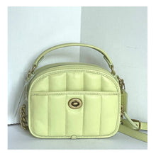 Load image into Gallery viewer, Light green handbag with gold accents on a white background