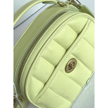 Load image into Gallery viewer, Light green quilted handbag with a gold lock on a light gray background