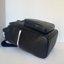 Load image into Gallery viewer, Black leather bag with a white strap on a light gray background
