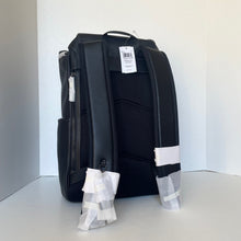 Load image into Gallery viewer, Black backpack with tags on a white background