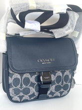 Load image into Gallery viewer, Coach handbag with patterned strap on a white background