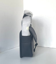 Load image into Gallery viewer, Black leather pouch with a white item inside on a white background