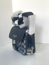 Load image into Gallery viewer, Coach handbag with decorative ribbons on a white background