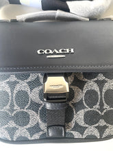 Load image into Gallery viewer, Coach bag with patterned strap and visible brand logo