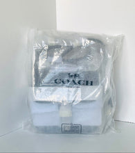 Load image into Gallery viewer, Coach bag in clear plastic packaging on a white background