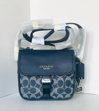 Load image into Gallery viewer, Coach handbag with clear plastic cover on a white background