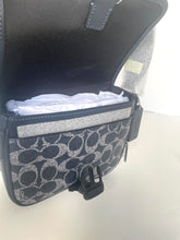Load image into Gallery viewer, Coach bag with a patterned compartment on a white background