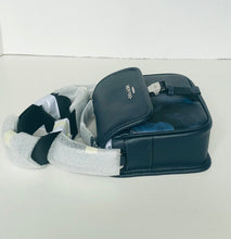 Load image into Gallery viewer, Black leather bag with a patterned sock on a white background