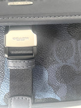 Load image into Gallery viewer, Coach handbag with logo on a strap and 'New York' tag.