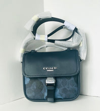 Load image into Gallery viewer, Coach handbag with a white towel on a light gray background