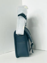 Load image into Gallery viewer, Blue leather wallet with gray socks inside on a white background