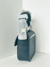 Load image into Gallery viewer, Gray pouch with a striped sock inside on a white background