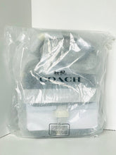 Load image into Gallery viewer, Coach bag in clear plastic packaging on a white background