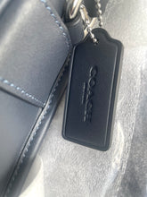 Load image into Gallery viewer, Coach keychain tag attached to a gray leather bag