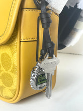 Load image into Gallery viewer, Yellow textured bag with a keychain featuring a Coca-Cola bottle cap on a white surface.