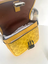Load image into Gallery viewer, Open handbag with yellow patterned interior on a white background