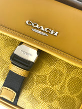 Load image into Gallery viewer, Close-up of a Coach bag with visible branding.