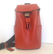 Load image into Gallery viewer, Red backpack with a strap and tag on a white background