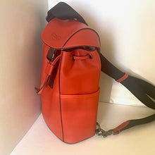 Load image into Gallery viewer, Red leather bag with a black strap on a light background