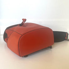 Load image into Gallery viewer, Red leather bag with a black strap on a white background
