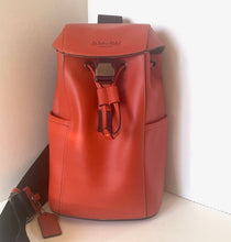 Load image into Gallery viewer, Red leather backpack on a white surface with a neutral background