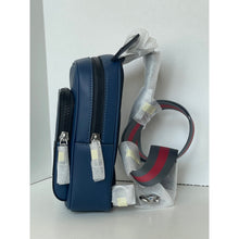 Load image into Gallery viewer, Blue backpack with a clear plastic cover on a white background