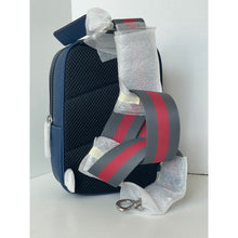 Load image into Gallery viewer, Blue bag with a red and gray strap on a white background
