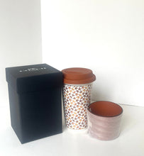 Load image into Gallery viewer, A reusable coffee cup with a brown lid and a geometric pattern, shown next to a matching empty cup and a black branded box on a white background.