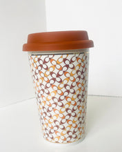 Load image into Gallery viewer, A reusable paper coffee cup with a brown lid, featuring an all-over interlocking arch pattern in brown, tan, and cream on a white background.