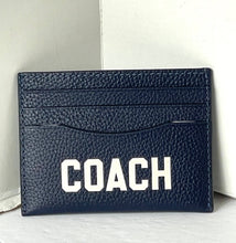 Load image into Gallery viewer, Navy blue Coach cardholder on a light gray surface with a white background