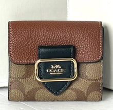 Load image into Gallery viewer, Coach wallet with brown leather top and patterned body on a white background