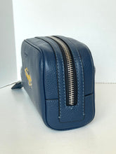 Load image into Gallery viewer, A navy blue pebbled leather cosmetic pouch with a gold-tone Coach logo on the side and a silver zipper, shown on a plain white background.