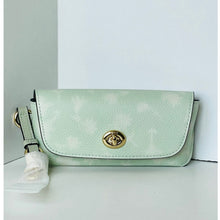 Load image into Gallery viewer, Mint green handbag with a gold clasp on a light gray background