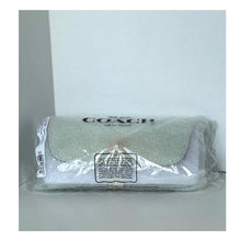 Load image into Gallery viewer, Coach clutch in clear plastic packaging on a light gray background