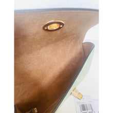 Load image into Gallery viewer, Close-up of a brown leather handbag with gold accents on a white background