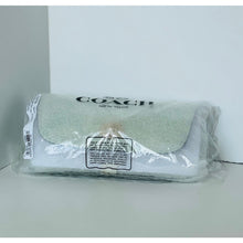 Load image into Gallery viewer, Coach pouch in clear plastic packaging on a white background