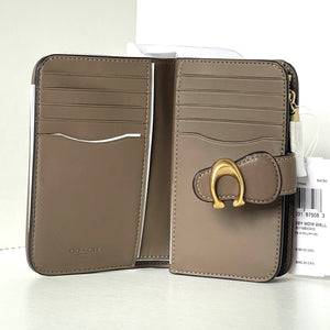 Brown wallet with gold clasp on a white background