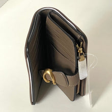 Load image into Gallery viewer, Brown leather wallet with gold accents on a white background