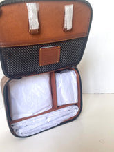 Load image into Gallery viewer, Open suitcase with folded clothes on a white background