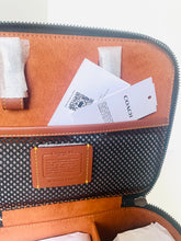 Load image into Gallery viewer, Brown leather bag with Coach branding and tags on a white background