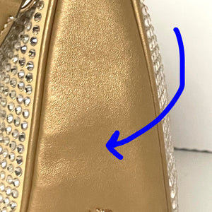 Gold handbag with rhinestone detailing on a white background
