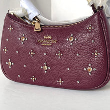 Load image into Gallery viewer, Coach handbag with gemstone embellishments on a white background