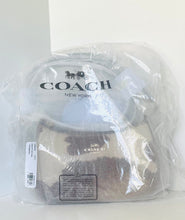 Load image into Gallery viewer, A Coach New York handbag inside a clear plastic protective bag, showing the beige and brown textured leather and the black Coach logo.