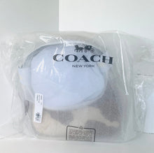 Load image into Gallery viewer, A Coach New York baseball cap in a light blue and gray colorway, sealed inside a clear plastic bag with the Coach logo printed on the front.