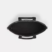 Load image into Gallery viewer, Black leather handbag with handles on a white background