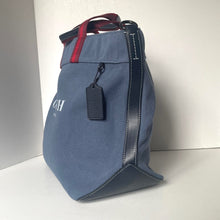 Load image into Gallery viewer, Blue bag with a red strap on a white background