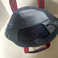 Load image into Gallery viewer, Gray bag with red straps on a white surface