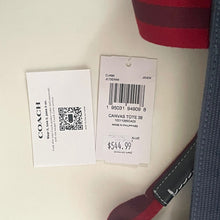 Load image into Gallery viewer, Close-up of a Coach product with price tag and QR code label.