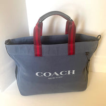 Load image into Gallery viewer, Blue Coach bag with red handles on a light background